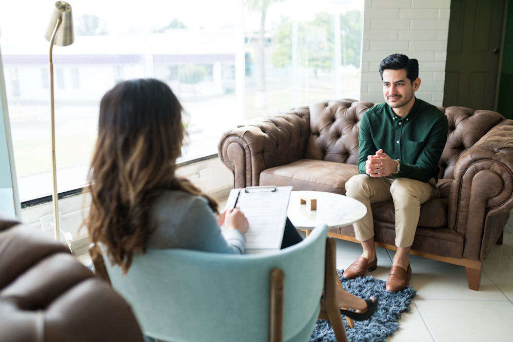 man sitting in individual therapy