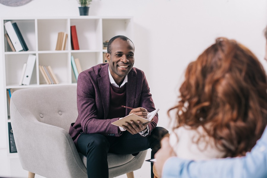 addiction-therapy Smiling man sitting in a chair for addiction treatment