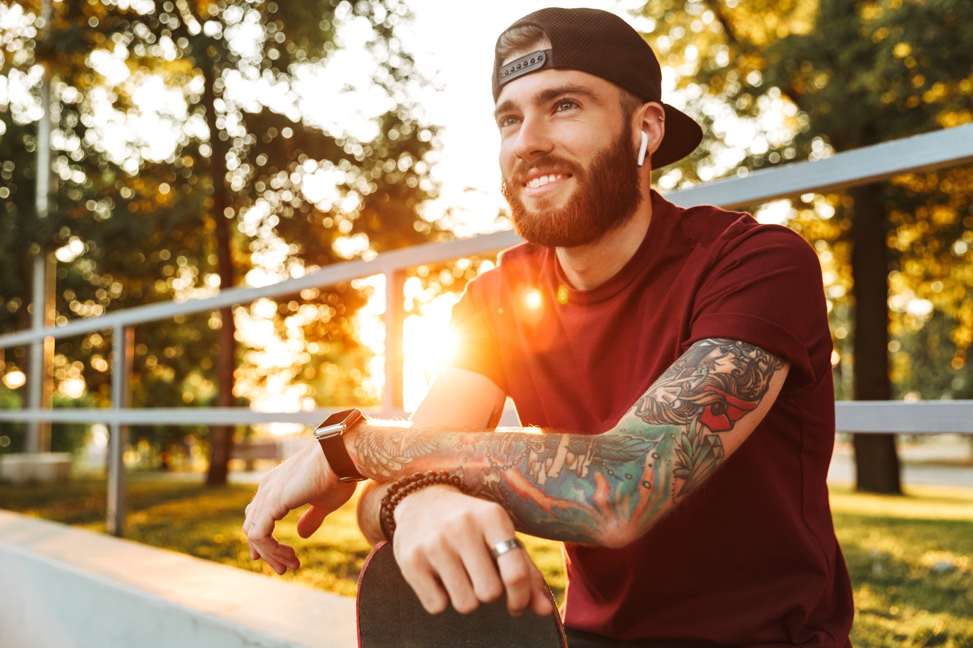 what-to-pack-for-rehab Man with tattoos listening on earbuds while relaxing on skate ramp